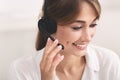 Smiling Girl In Headset Receiving Customer`s Call Over White Background