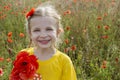 Smiling girl holding bouquet poppies