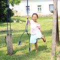 Smiling girl holding a broken swing