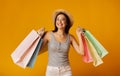 Smiling Girl Holding Colorful Shopping Bags On Yellow Studio Background Royalty Free Stock Photo