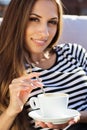 Smiling girl is holding cup of coffee, autumn time Royalty Free Stock Photo