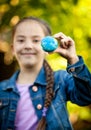 Smiling girl holding little Earth at hand Royalty Free Stock Photo