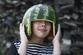 Smiling girl holding melon hemlet on her head Royalty Free Stock Photo