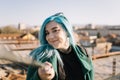 Smiling girl holding a selfie stick and looking into a camera Royalty Free Stock Photo