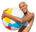 Smiling girl holds inflatable beach ball, wearing bikini feels great, African latin American woman isolated on white background. Royalty Free Stock Photo