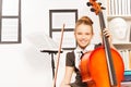 Smiling girl holds string to play violoncello Royalty Free Stock Photo