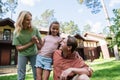Smiling girl hugging parents on lawn Royalty Free Stock Photo