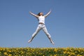 Smiling girl jumping in field Royalty Free Stock Photo