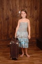Smiling girl keep ancient brown scratched suitcase
