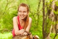 Smiling girl laying on the log at sunny day Royalty Free Stock Photo