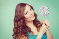 Smiling girl with lollipop candy on teal Royalty Free Stock Photo