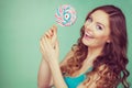 Smiling girl with lollipop candy on teal Royalty Free Stock Photo