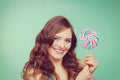 Smiling girl with lollipop candy on teal Royalty Free Stock Photo