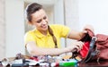 Smiling girl looking for something in handbag Royalty Free Stock Photo