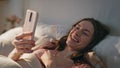 Smiling girl making video call at home closeup. Relaxed female talking online