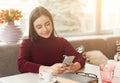 Smiling girl messaging on mobile at cafe Royalty Free Stock Photo