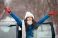 Happy Female Driver Standing By Her Car Admiring the Snow Royalty Free Stock Photo