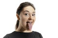 Smiling girl opening her mouth and showing the long big giant tongue isolated on white background, crazy and attracted Royalty Free Stock Photo