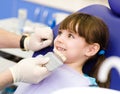 Smiling girl with palette for tooth color