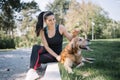 Smiling girl petting dog who is lying on ground