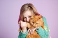 Smiling girl playing with her fluffy cat. Royalty Free Stock Photo