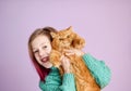 Smiling girl playing with her fluffy cat. Royalty Free Stock Photo