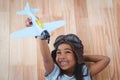 Smiling girl playing with toy airplane Royalty Free Stock Photo