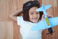 Smiling girl playing with toy airplane Royalty Free Stock Photo