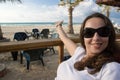 Smiling girl point to the sea beach Royalty Free Stock Photo