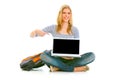 Smiling girl pointing on laptop with blank screen Royalty Free Stock Photo
