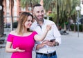 Smiling girl is pointing the way for young stranger