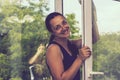 Smiling girl polishing the glass with cloth. Attractive Woman Washing the Window. Cleaning Company worker working Royalty Free Stock Photo