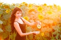 Smiling girl pours sunflower oil from the jug Royalty Free Stock Photo