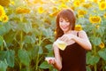 Smiling girl pours sunflower oil from a jug into a bowl Royalty Free Stock Photo