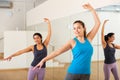 Smiling girl practicing ballet dance moves in choreographic studio Royalty Free Stock Photo