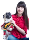 Smiling girl with a pug dog in a sweater Royalty Free Stock Photo