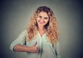 Smiling girl raises right thumb up Royalty Free Stock Photo