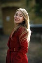 Young woman walking wearing red coat Royalty Free Stock Photo