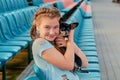 Smiling girl relaxing with dog. girl with her pet on the seats of the stadium Royalty Free Stock Photo