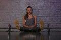 Smiling girl resting on the gym, feet on the bar Royalty Free Stock Photo