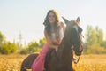 smiling girl riding a horse in a pink Royalty Free Stock Photo
