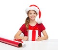 Smiling girl in santa helper hat with gift box Royalty Free Stock Photo