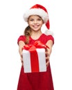 Smiling girl in santa helper hat with gift box Royalty Free Stock Photo