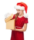 Smiling girl in santa helper hat with gift box Royalty Free Stock Photo