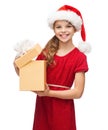 Smiling girl in santa helper hat with gift box Royalty Free Stock Photo