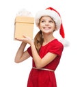 Smiling girl in santa helper hat with gift box Royalty Free Stock Photo