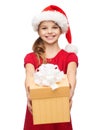 Smiling girl in santa helper hat with gift box Royalty Free Stock Photo