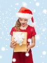 Smiling girl in santa helper hat with gift box Royalty Free Stock Photo