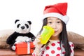 Smiling girl in santa helper hat with teddy bear