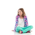 Smiling girl sitting with legs crossed Royalty Free Stock Photo